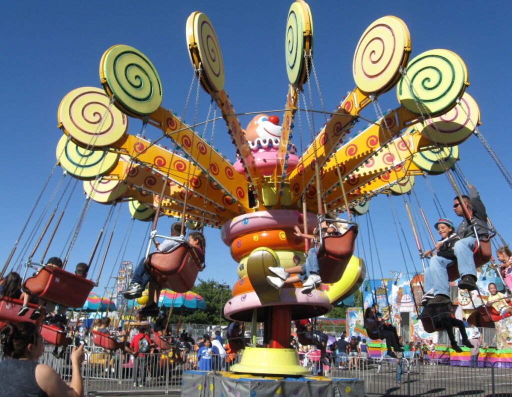 Visitors riding a colorful swing ride at the New Mexico State Fair in 2010