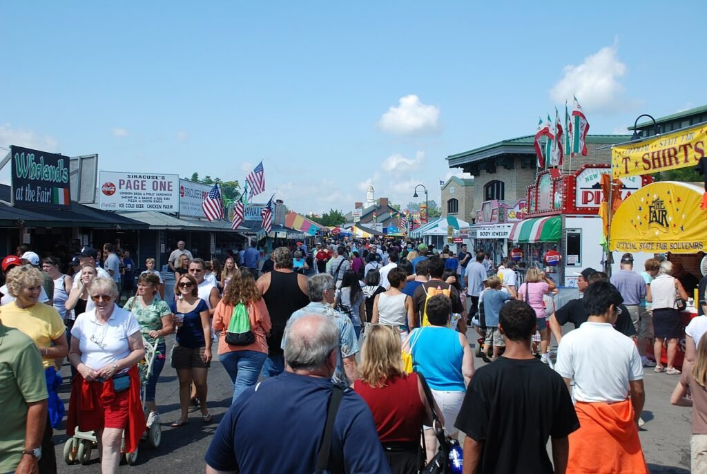 Visitors walking between food booths and exhibits at the New York State Fair in 2008